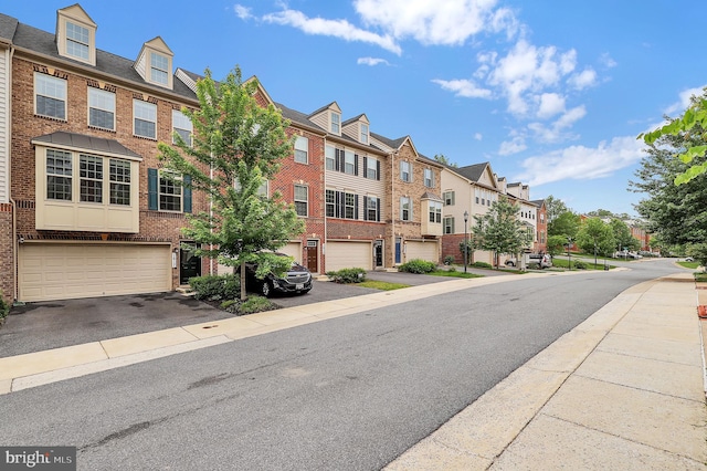 view of asphalt road featuring a residential view and sidewalks