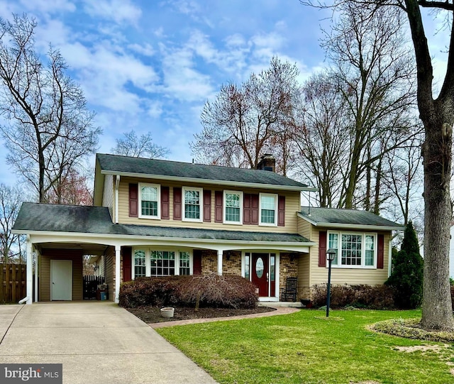 8807 Falkstone Ln, Alexandria, VA 22309 - split level home featuring a chimney, fence, a carport, a front yard, and driveway