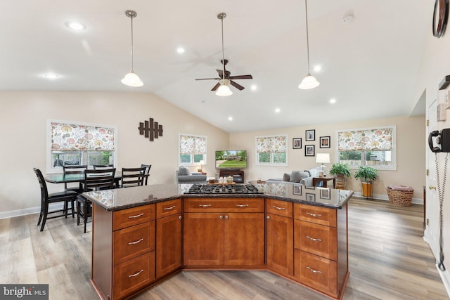 8807 Falkstone Ln, Alexandria, VA 22309 - kitchen with a ceiling fan, dark stone counters, open floor plan, light wood-type flooring, and lofted ceiling