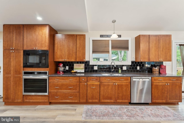 8807 Falkstone Ln, Alexandria, VA 22309 - kitchen with brown cabinetry, stainless steel appliances, and a sink
