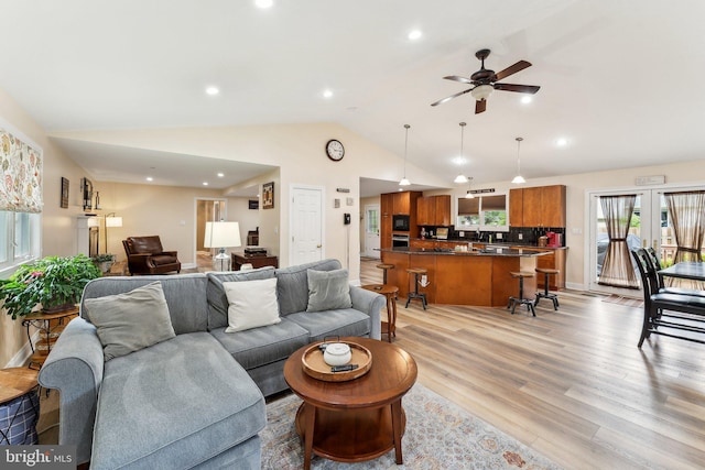 8807 Falkstone Ln, Alexandria, VA 22309 - living room with light wood finished floors, lofted ceiling, ceiling fan, and recessed lighting