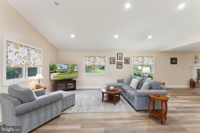 8807 Falkstone Ln, Alexandria, VA 22309 - living room with light wood finished floors, lofted ceiling, and recessed lighting