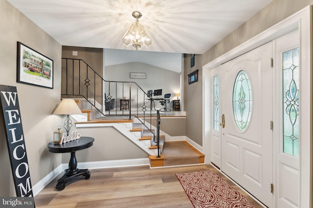 8807 Falkstone Ln, Alexandria, VA 22309 - entrance foyer featuring a wealth of natural light, stairway, an inviting chandelier, and wood finished floors