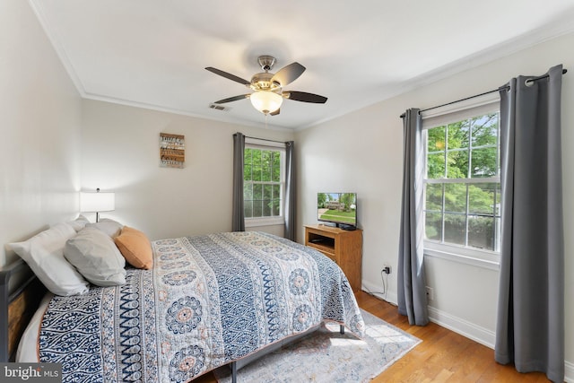 8807 Falkstone Ln, Alexandria, VA 22309 - bedroom with light wood-style flooring, a ceiling fan, crown molding, visible vents, and baseboards