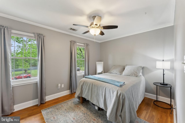 8807 Falkstone Ln, Alexandria, VA 22309 - bedroom with multiple windows, wood finished floors, and baseboards