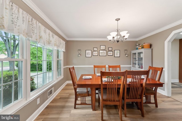 8807 Falkstone Ln, Alexandria, VA 22309 - dining room featuring ornamental molding, a notable chandelier, and light wood-type flooring