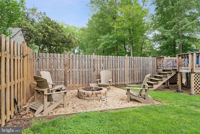 8807 Falkstone Ln, Alexandria, VA 22309 - view of yard with a fenced backyard, a wooden deck, stairs, and a fire pit