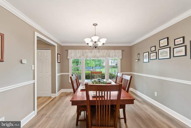 8807 Falkstone Ln, Alexandria, VA 22309 - dining area featuring an inviting chandelier, crown molding, baseboards, and light wood-type flooring