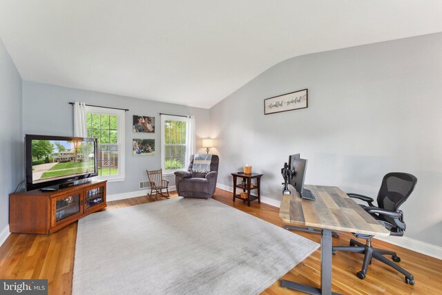 8807 Falkstone Ln, Alexandria, VA 22309 - home office featuring lofted ceiling, baseboards, visible vents, and wood finished floors