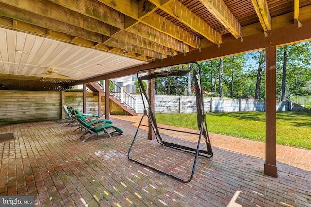 view of patio with stairs, a ceiling fan, and fence