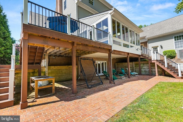 view of patio featuring stairway, a wooden deck, french doors, and a sunroom