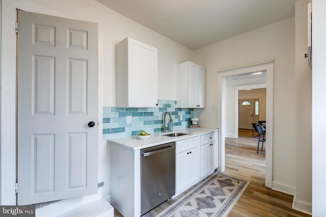 615 Burke Ave, Jenkintown, PA 19046 - kitchen with stainless steel dishwasher, a sink, white cabinetry, light countertops, and baseboards
