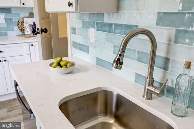 615 Burke Ave, Jenkintown, PA 19046 - kitchen view of a sink, tasteful backsplash, and white cabinets