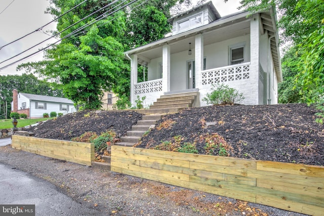 615 Burke Ave, Jenkintown, PA 19046 - view of front facade featuring covered porch, stairway, and brick siding