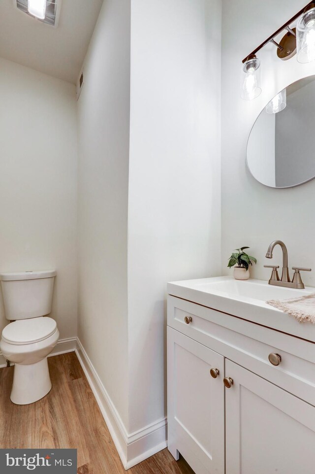 615 Burke Ave, Jenkintown, PA 19046 - half bathroom with wood finished floors, toilet, vanity, and baseboards