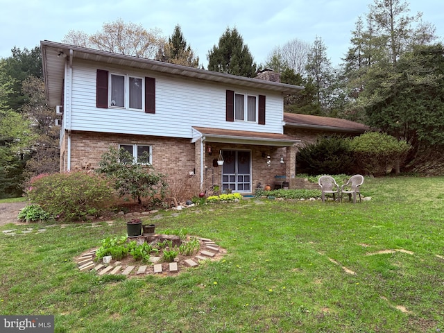 traditional-style house with a front lawn, a chimney, and brick siding