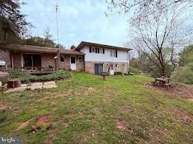 back of property with a yard