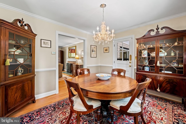 1902 Northleigh Rd, Lutherville Timonium, MD 21093 - dining space featuring a chandelier, light wood finished floors, crown molding, and baseboards