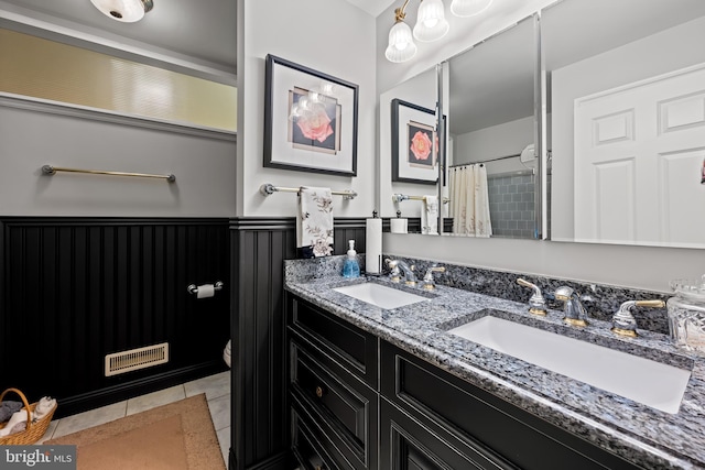 1902 Northleigh Rd, Lutherville Timonium, MD 21093 - full bath featuring tile patterned floors, toilet, a wainscoted wall, and double vanity