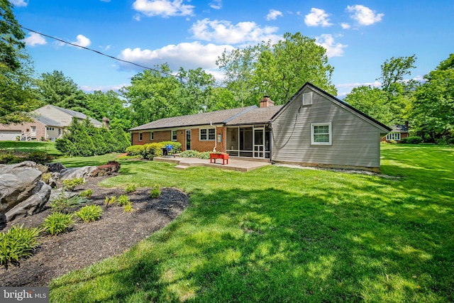 1902 Northleigh Rd, Lutherville Timonium, MD 21093 - rear view of property with a sunroom, a patio, a chimney, a yard, and brick siding