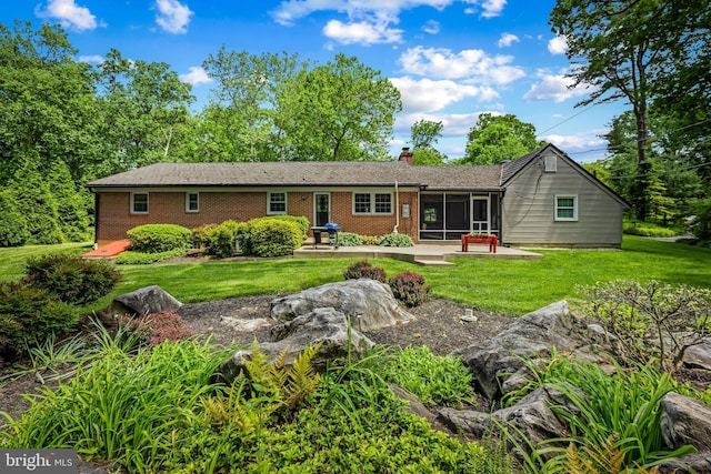 1902 Northleigh Rd, Lutherville Timonium, MD 21093 - back of house featuring a sunroom, a chimney, a yard, brick siding, and a patio area