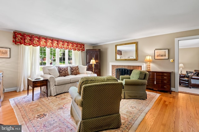 1902 Northleigh Rd, Lutherville Timonium, MD 21093 - living room featuring crown molding, light wood finished floors, and a brick fireplace