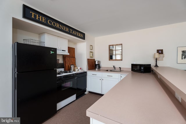 kitchen with light countertops, black appliances, under cabinet range hood, dark carpet, and white cabinetry