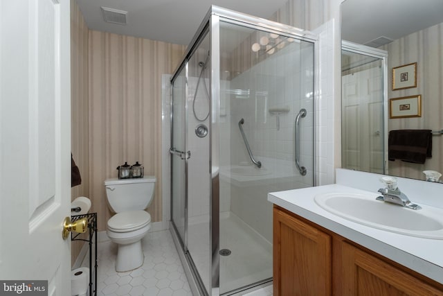 full bath featuring toilet, wallpapered walls, a shower stall, and vanity