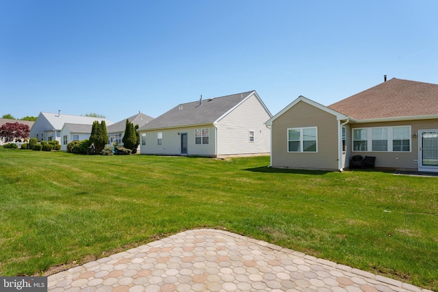 rear view of property with a yard