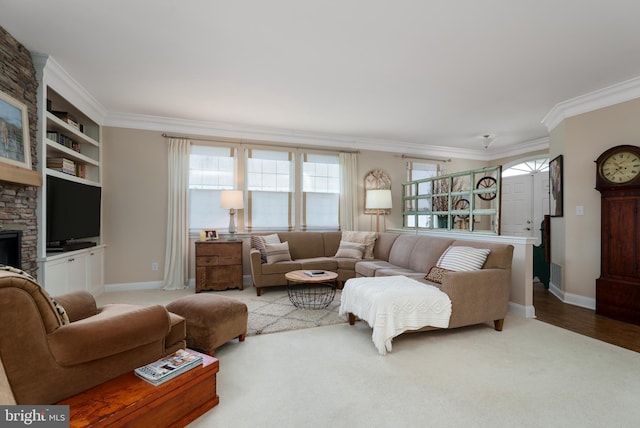 carpeted living area with baseboards, ornamental molding, and built in shelves