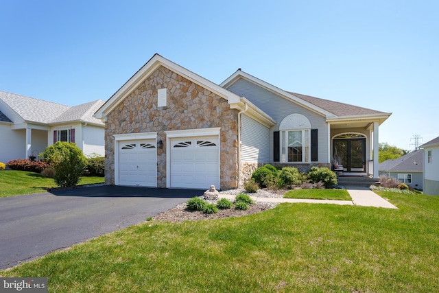 ranch-style house with a front yard, an attached garage, driveway, and stone siding