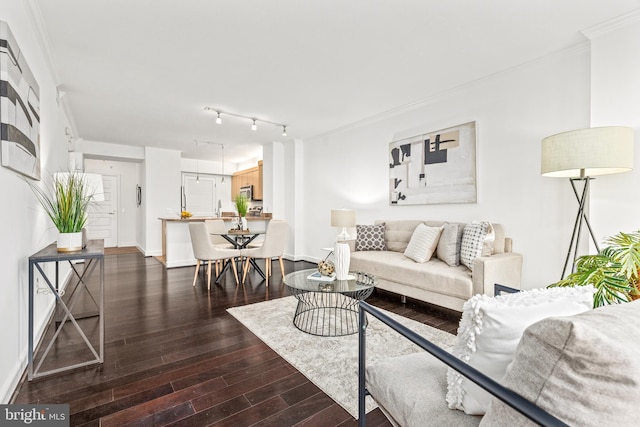 living area featuring baseboards, ornamental molding, and dark wood finished floors