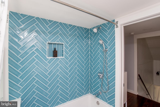full bathroom featuring bathtub / shower combination and wood finished floors