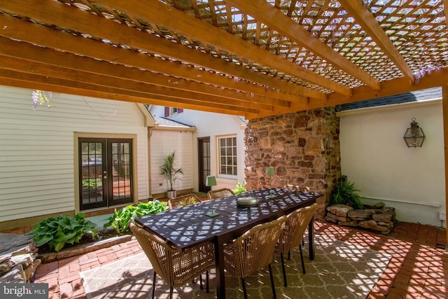 view of patio / terrace featuring french doors, a pergola, and outdoor dining space