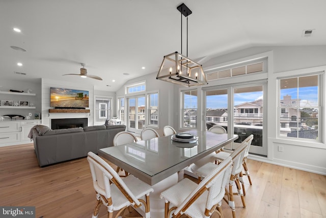 15 W Harding Ave, Long Beach Township, NJ 08008 - dining space featuring lofted ceiling, light wood finished floors, a fireplace, recessed lighting, and a chandelier
