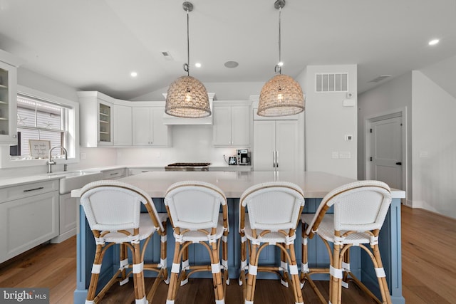 15 W Harding Ave, Long Beach Township, NJ 08008 - kitchen with a sink, a kitchen breakfast bar, light countertops, vaulted ceiling, and recessed lighting