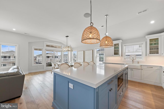 15 W Harding Ave, Long Beach Township, NJ 08008 - kitchen with a sink, white cabinetry, light wood-style floors, open floor plan, and recessed lighting