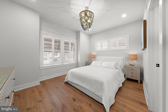 15 W Harding Ave, Long Beach Township, NJ 08008 - bedroom with a chandelier, multiple windows, light wood-style flooring, baseboards, and recessed lighting
