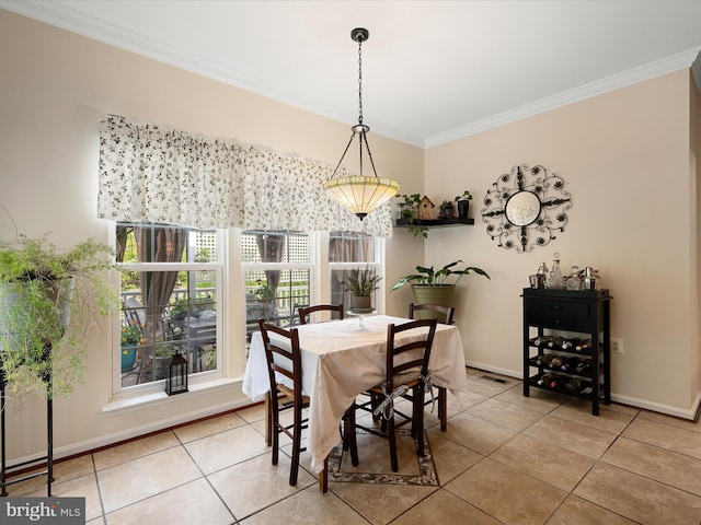 dining area featuring ornamental molding, tile patterned flooring, visible vents, and baseboards