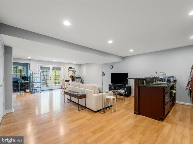 living room with light wood finished floors, recessed lighting, french doors, and baseboards