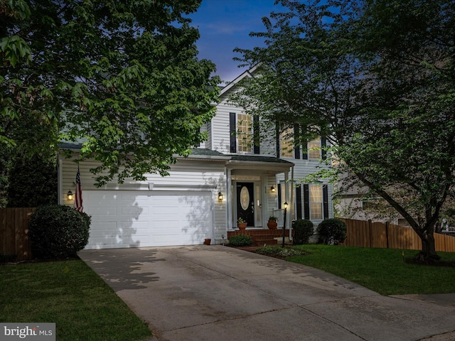 view of front facade with a garage, fence, a front yard, and concrete driveway