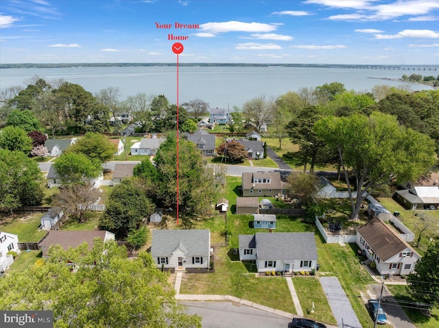 aerial view of residential area featuring a large body of water