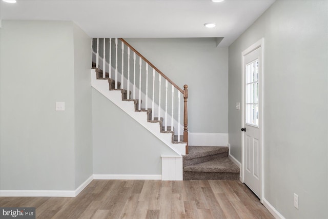 entrance foyer featuring wood finished floors, stairway, recessed lighting, and baseboards