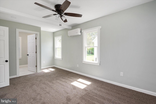 unfurnished bedroom featuring a wall unit AC, multiple windows, carpet floors, and baseboards