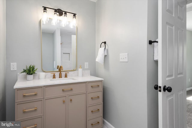 bathroom with vanity and baseboards