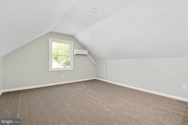 bonus room with an AC wall unit, carpet, vaulted ceiling, and baseboards