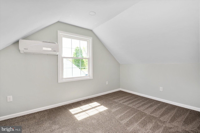 bonus room with a wall mounted AC, carpet floors, vaulted ceiling, and baseboards