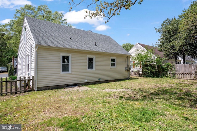 back of property featuring a shingled roof