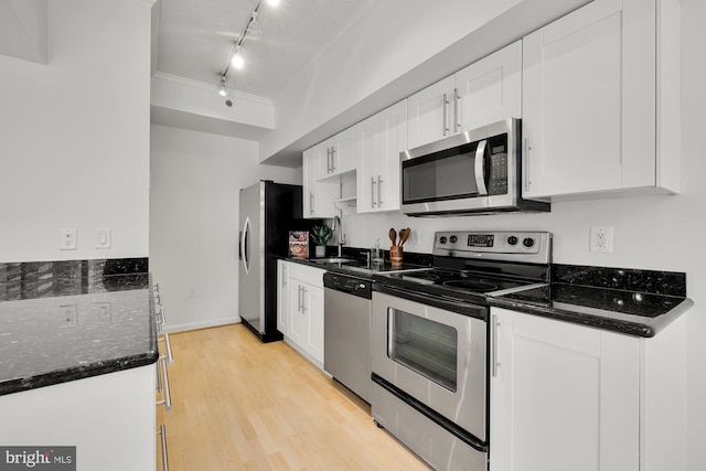 kitchen featuring track lighting, light wood finished floors, appliances with stainless steel finishes, and white cabinets
