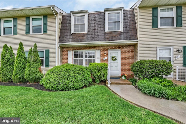 114 Dew Drop Ct, York, PA 17403 - townhome / multi-family property featuring a shingled roof, brick siding, and a front lawn